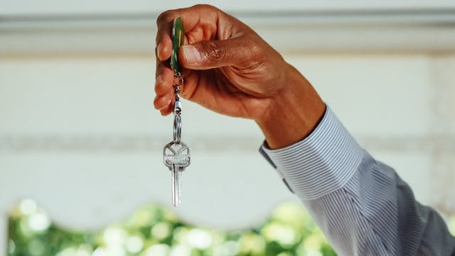 person-holding-silver-key