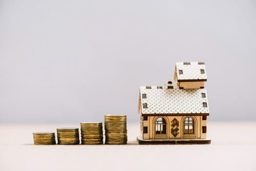 piles-coins-near-small-house piles-coins-near-small-house