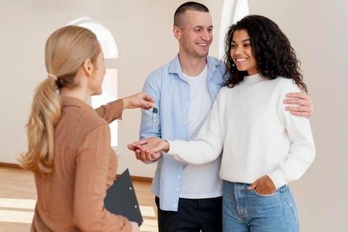 realtor-handing-smiley-couple-keys